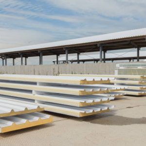 Metal frame of the building with a sandwich panel of insulation on the wall. Construction of a new industrial building. Modern Insulation of the walls of the building panels of insulation.
